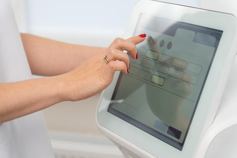 using a touchscreen on modern cosmetic equipment