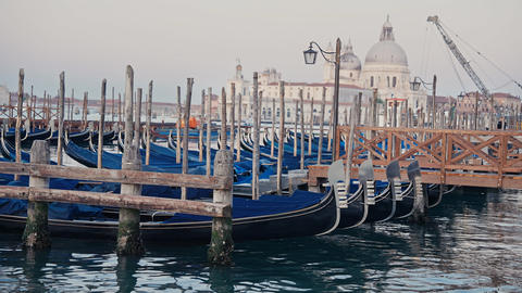 Gondolas on Venice canal with Basilica Santa Maria della Salute in background