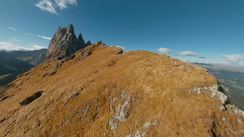 Smooth flight along the mountain range, filmed by FPV drone. Seceda, Italy