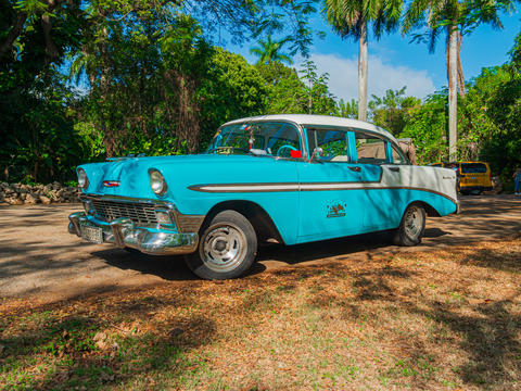 Retro blue car on a sunny tropical street