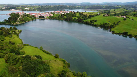 Wide aerial panoramic view of San Vicente de la Barquera estuary and coastline