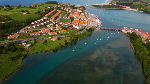 Wide aerial panoramic view of San Vicente de la Barquera estuary and coastline