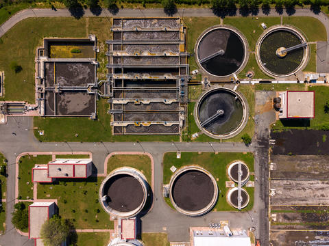 View of wastewater treatment plant from above in urban setting