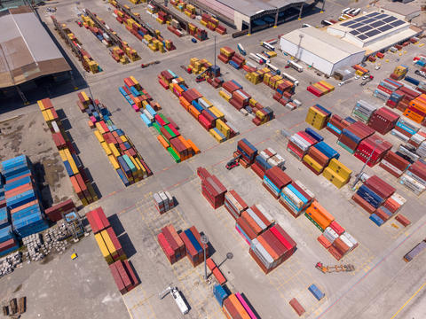 Container yard at a shipping port with stacked cargo boxes