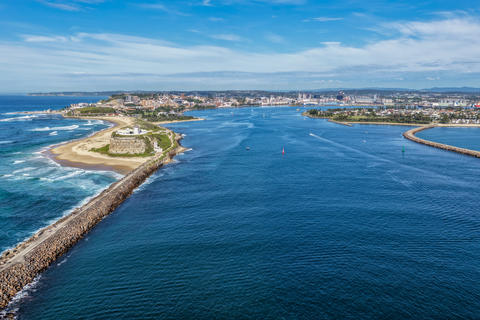 Aerial scene capturing Nobbys Lighthouse, Nobbys Beach and the Newcastle Harbour channel