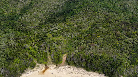 Aerial video flying backwards to reveal McBrides Beach near Forster