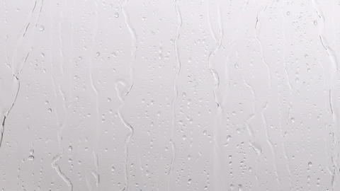 Raindrops falling from the window