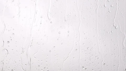 Raindrops falling from the window