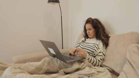 Woman working from home on laptop computer