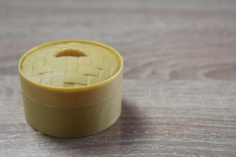 Round yellow box on a light background