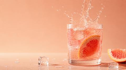 Refreshing drink splashes in glass