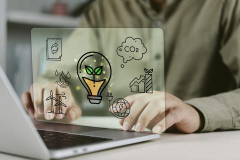 Business person using laptop with ESG environmental, social and governance hologram icons. Concept o