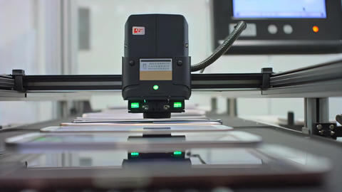 Optical inspection camera scanning pharmaceutical tablets in close-up, conveyor surface, automated