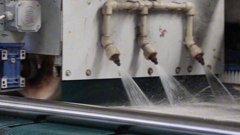 Textile carpet cleaning in an industrial machine