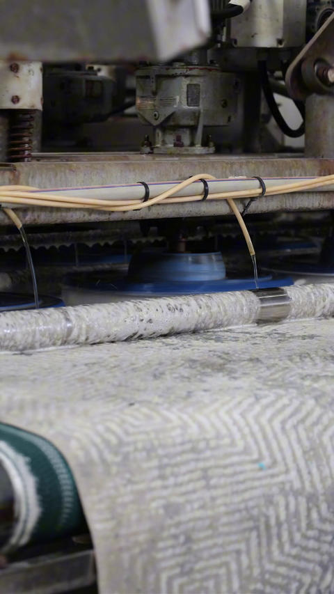 Textile carpet cleaning in an industrial machine
