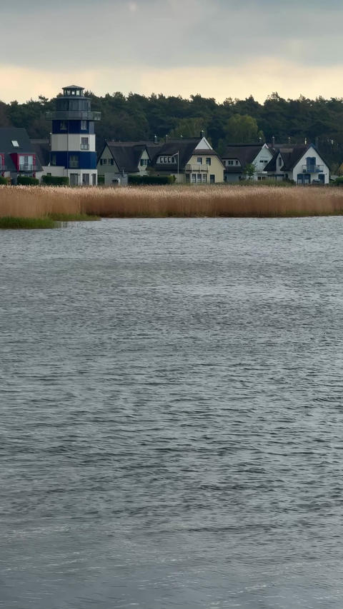 Village houses reflected in calm water in Breege on Ruegen island in Germany