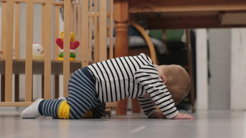 White baby crawling under table