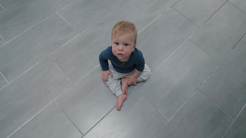 Baby sitting on tiled floor