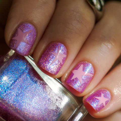 Pink star nail art close up with polish bottle