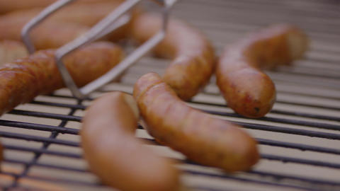 Grilled sausages cooking on a barbecue rack