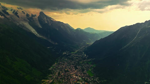 Establishing shot of French mountains in summer. Drone view of green meadows