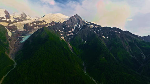 Establishing shot of French mountains in summer. Drone view of green meadows