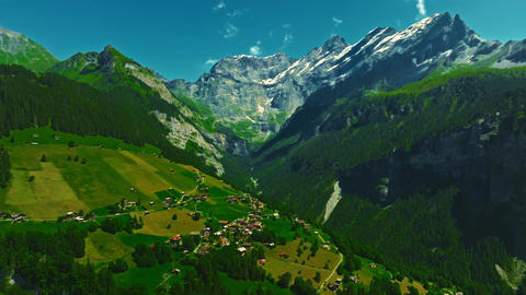 Establishing shot of Switzerland. Aerial view of the green meadows of