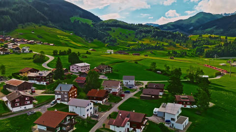 Establishing shot of Switzerland. Aerial view of the green meadows of