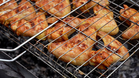 BBQ picnic time Roasted chicken legs and wings on grill. Grilling meat on