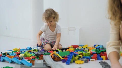 Child playing with scattered building blocks