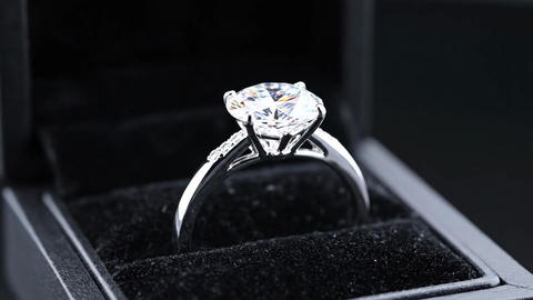Diamond Engagement Ring Rotating in a Matte Black Velvet Presentation Box