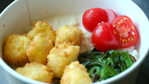 Healthy poke bowl with fried tofu and cherry tomatoes