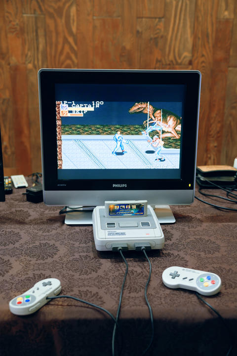 Retro home console setup with classic cartridge and CRT monitor showing side