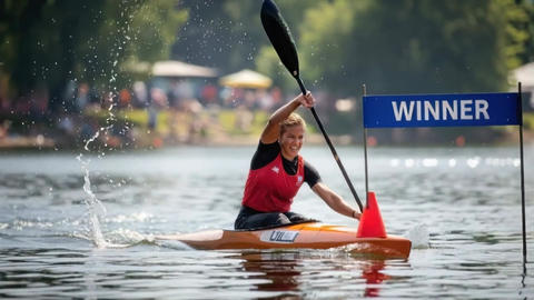 Kayaker crossing finish buoy during flatwater sprint race with powerful paddle