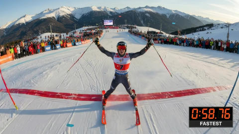 Alpine skier celebrating victory at downhill finish line on snowy mountain race