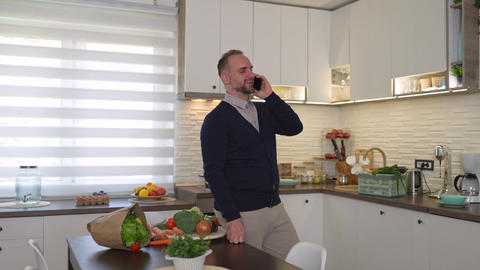 Professional man talking on the phone in a modern kitchen