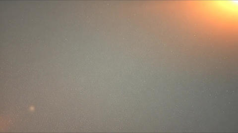 Warm Light Flare and Floating Dust Particles on Soft Gray Background