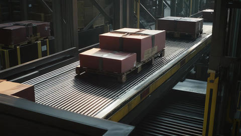 Logistics warehouse moving large boxes on conveyor belt