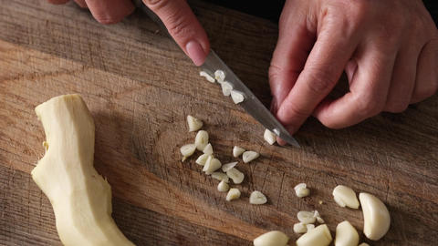 Woman Slicing Garlic