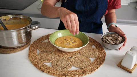 Woman Serving Sweet Potato Puree Soup