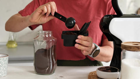 Woman Making Coffee In Coffee Machine