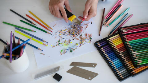 Woman Sharpening Pencils