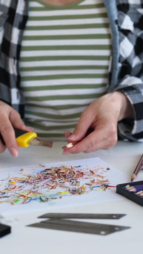 Woman Sharpening Colored Pencils