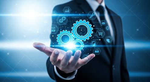 Businessman holding blue gear hologram for automation workflow and digital transformation technology