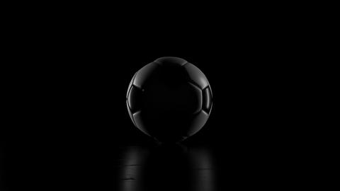 traditional black and white football rotating in low key light