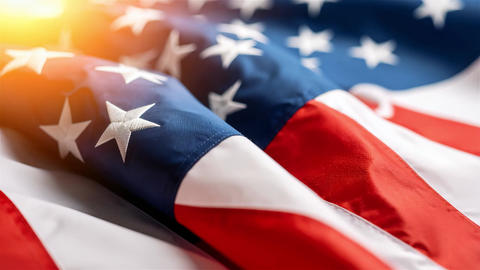 Close Up American Flag Waving With Warm Sunlight