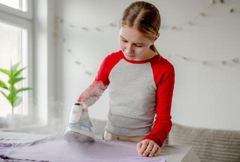 Teen Girl Ironing Clothes