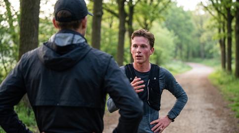 Running Coach Advising Athlete During Park Training Pause