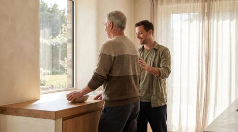 Older Adult Balance Guidance by Window in Warm Home Kitchen