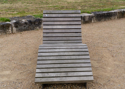 Wooden sun lounger on beach